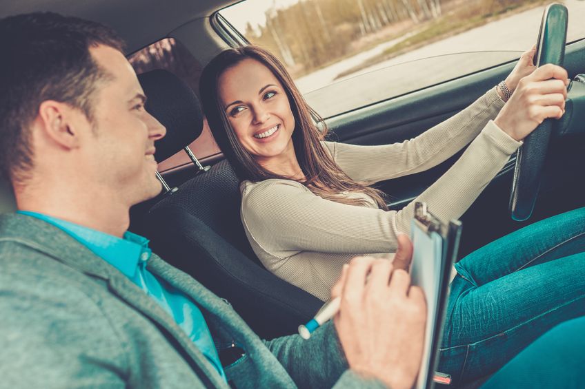 41522499 - driving instructor and woman student in examination car