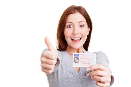 9319225 - happy woman with european driving license holding her thumbs up